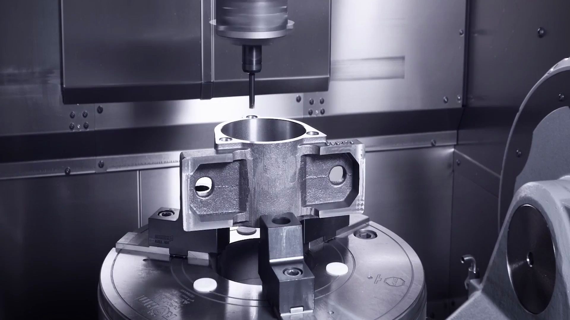 5-axis CNC machining center working on complex metal part