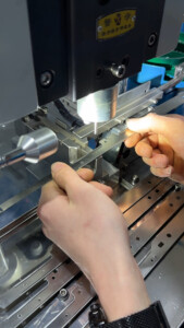 Precision sheet metal punching process producing accurate holes and shapes in metal components.